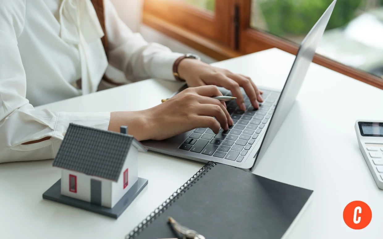 Real estate agent completing continuing education courses online at a professional workspace